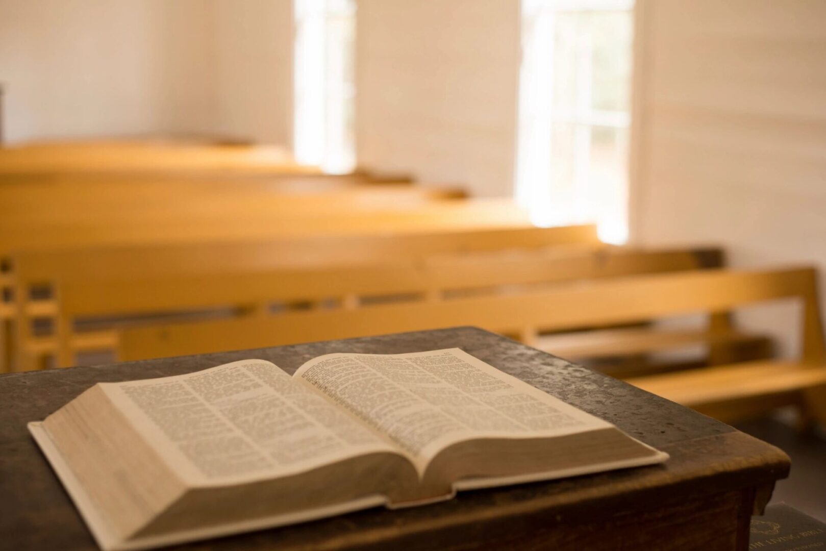 A book is open on the table in front of some benches.